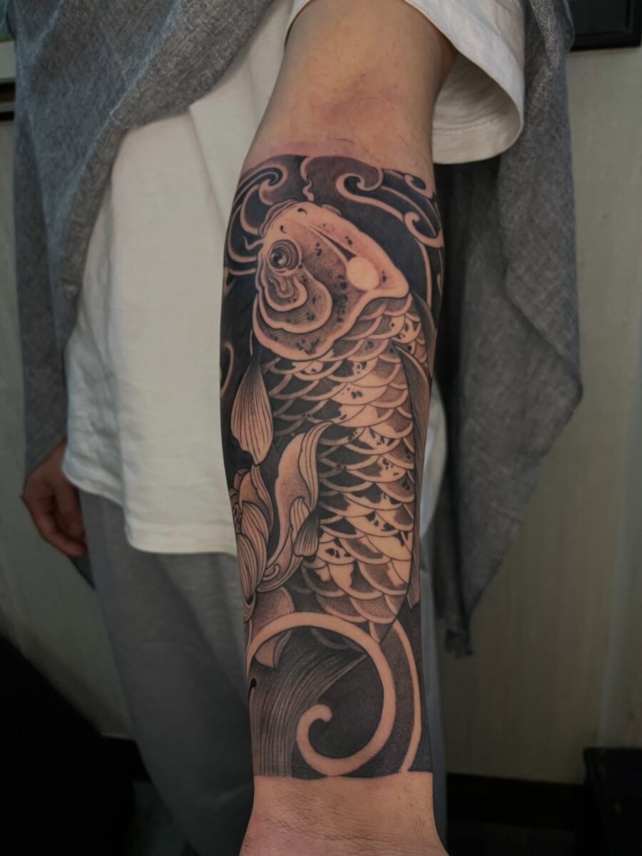 Elegant koi fish showcase in half sleeve tattoo