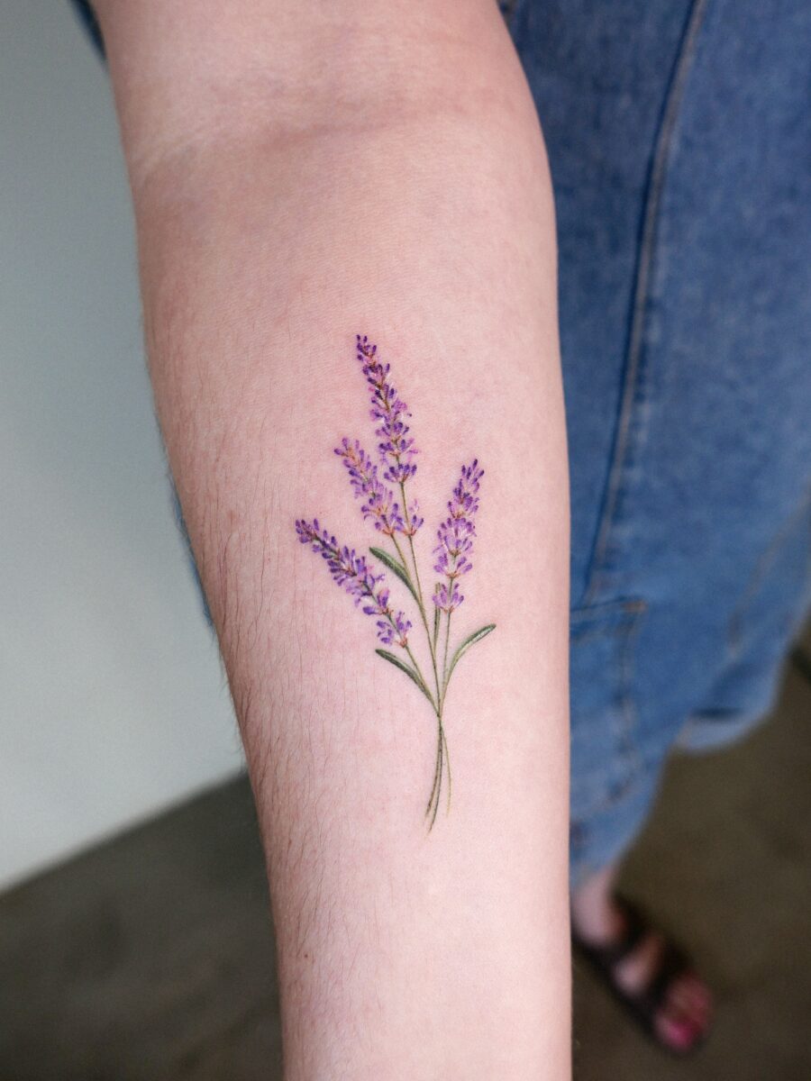Delicate lavender tattoo on forearm