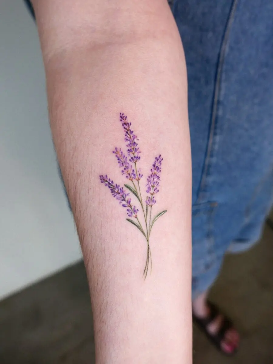 Delicate lavender tattoo on forearm
