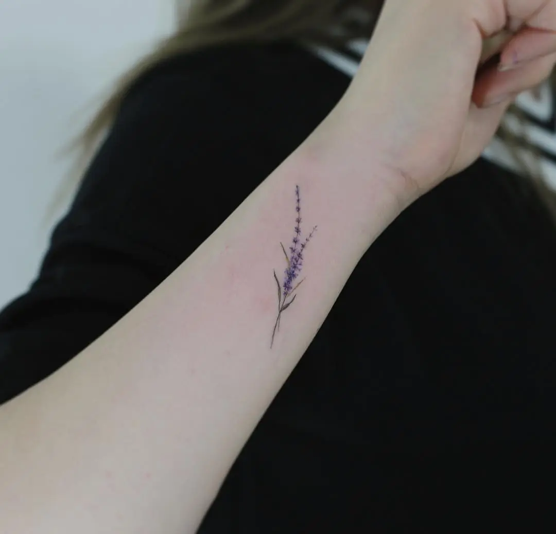Delicate lavender tattoo on the forearm