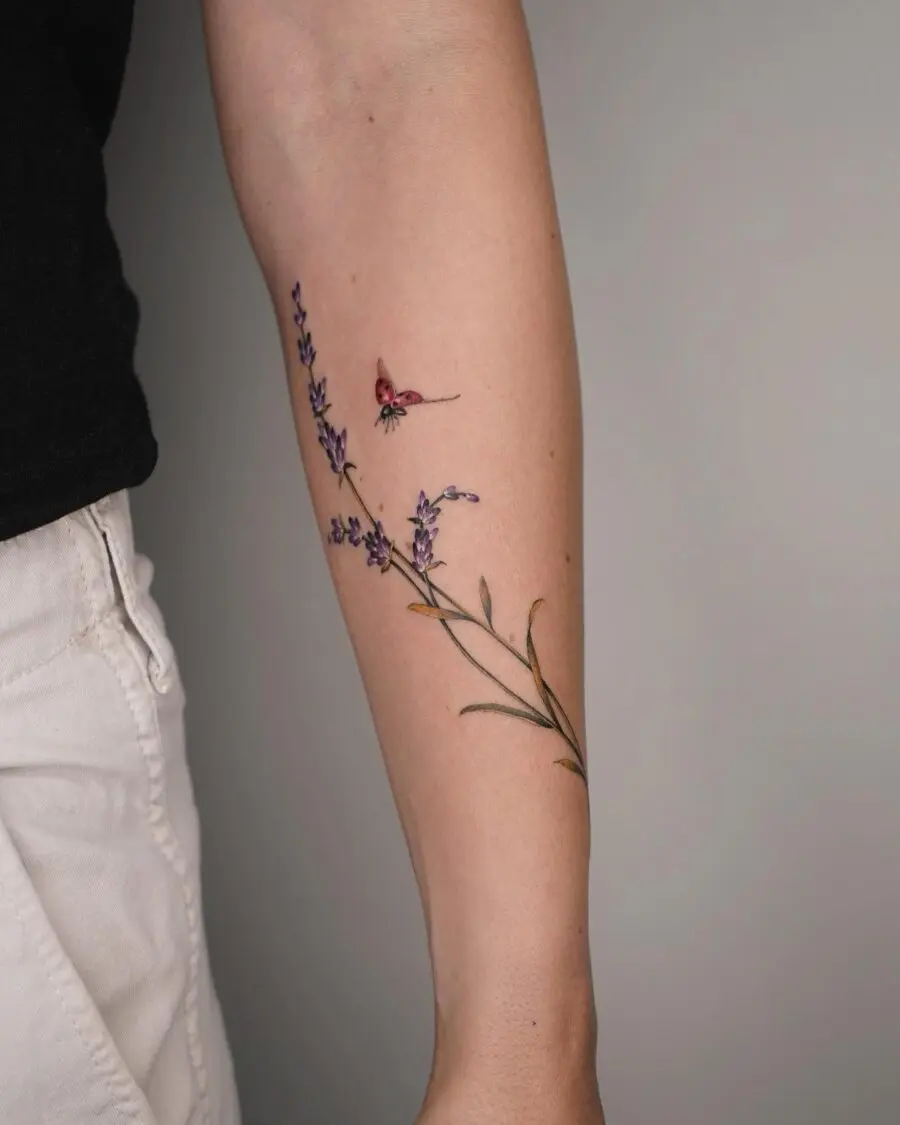 Delicate lavender tattoo with a butterfly accent