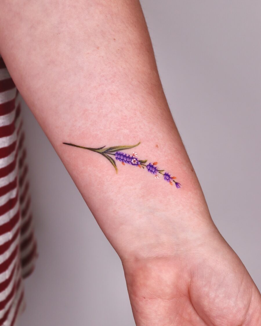 Delicate lavender tattoo design on forearm