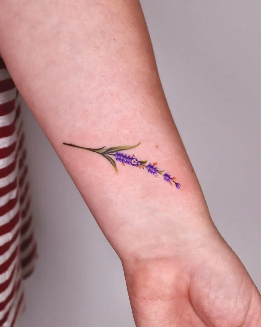 Delicate lavender tattoo design on forearm