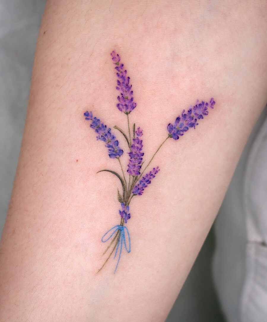 Stunning lavender tattoo bouquet with blue ribbon