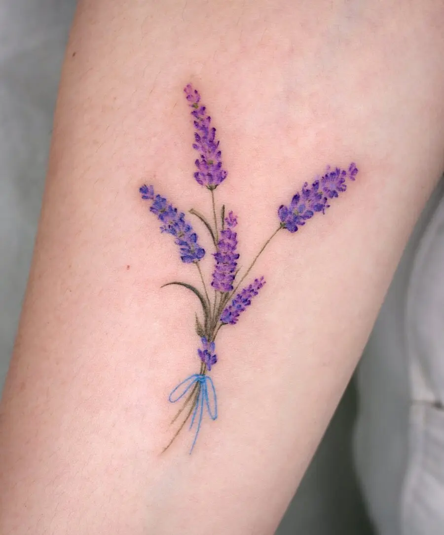 Stunning lavender tattoo bouquet with blue ribbon