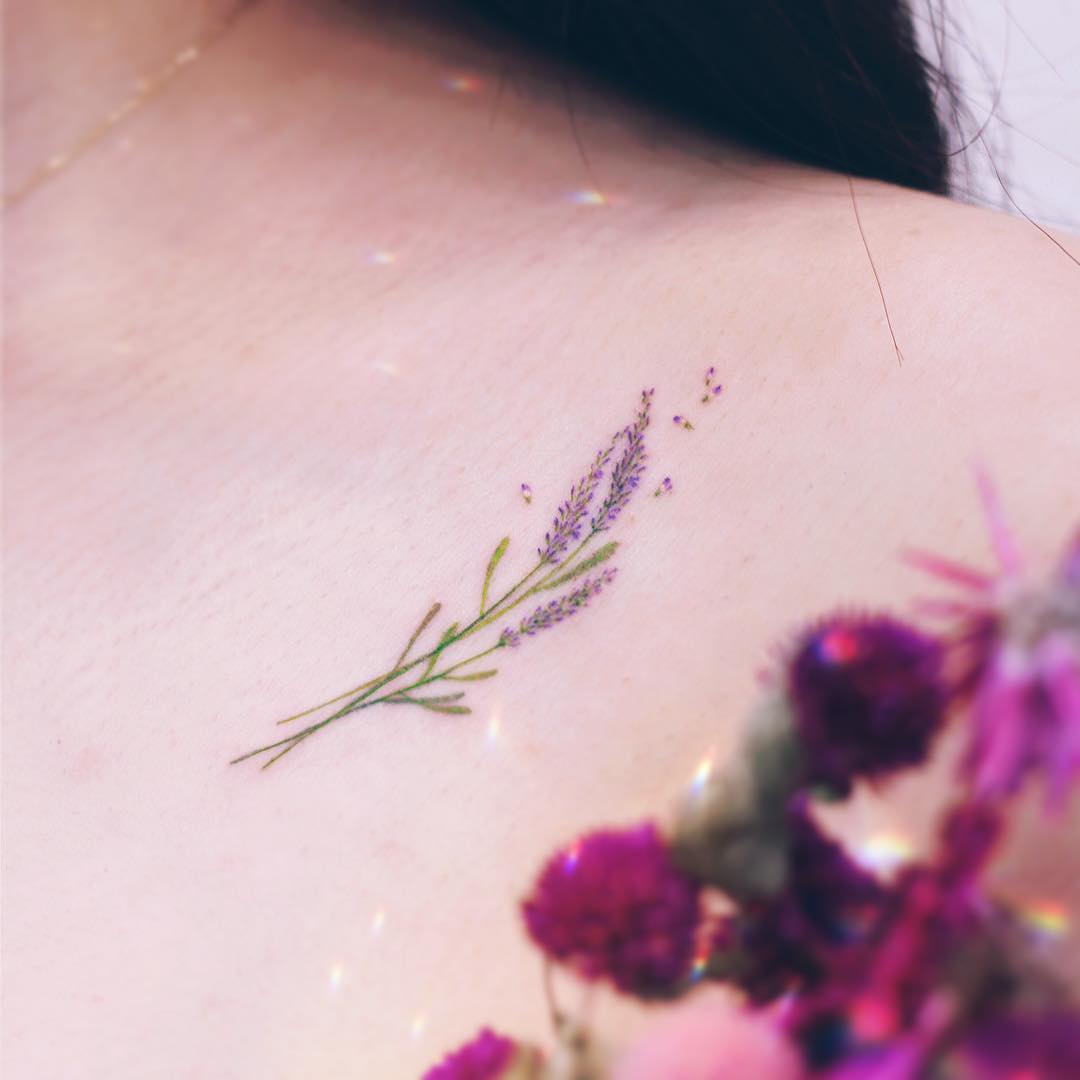 Delicate lavender tattoo on shoulder blossom.
