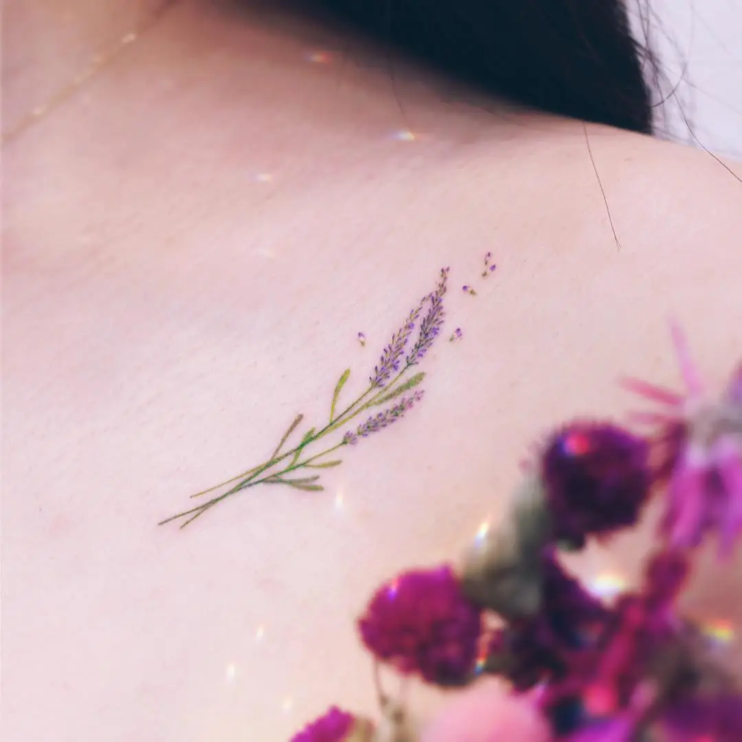 Delicate lavender tattoo on shoulder blossom.