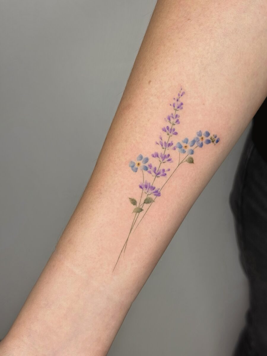 Elegant lavender tattoo on forearm