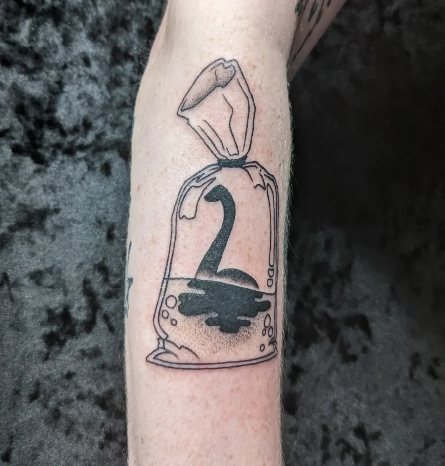 Unique Loch Ness Monster in a Bag Tattoo