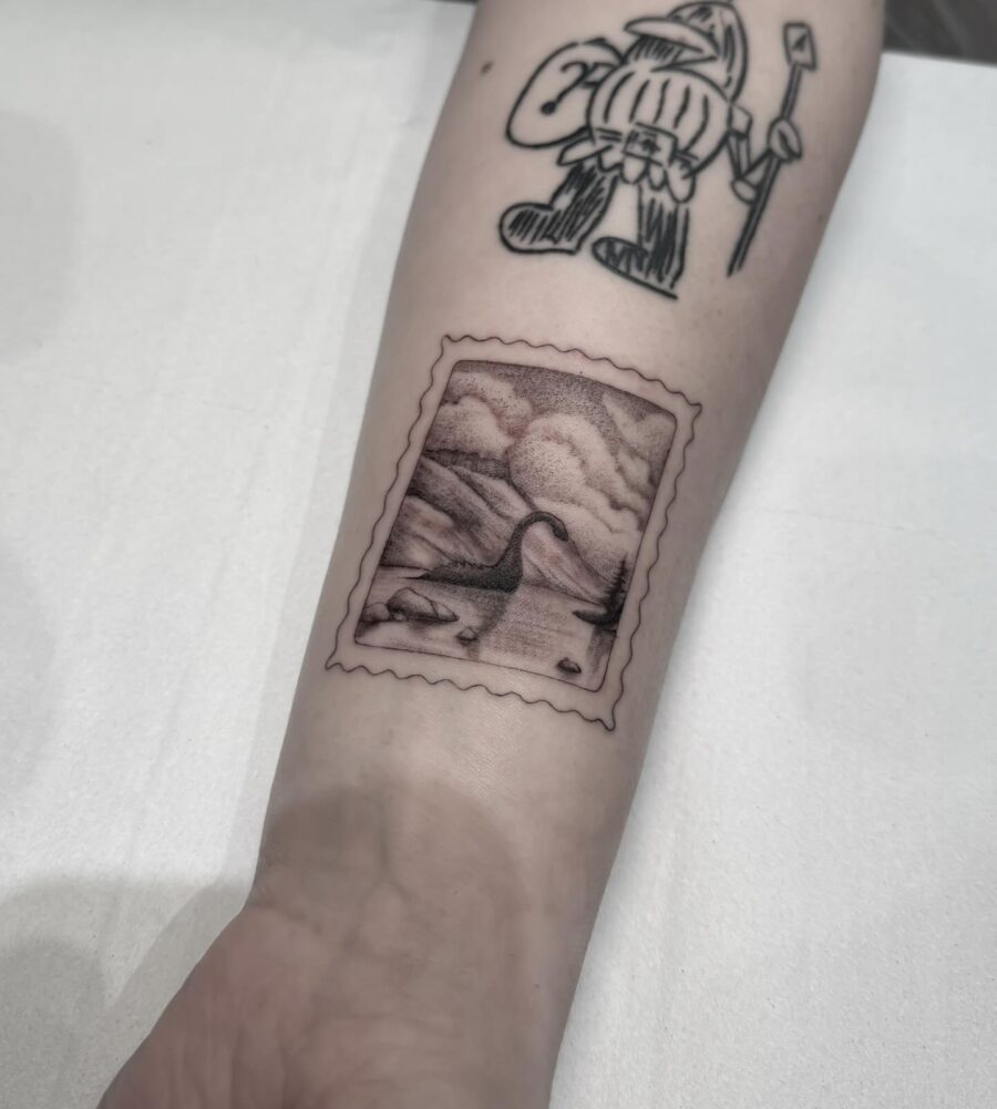 Intricate stamp-style Loch Ness monster tattoo