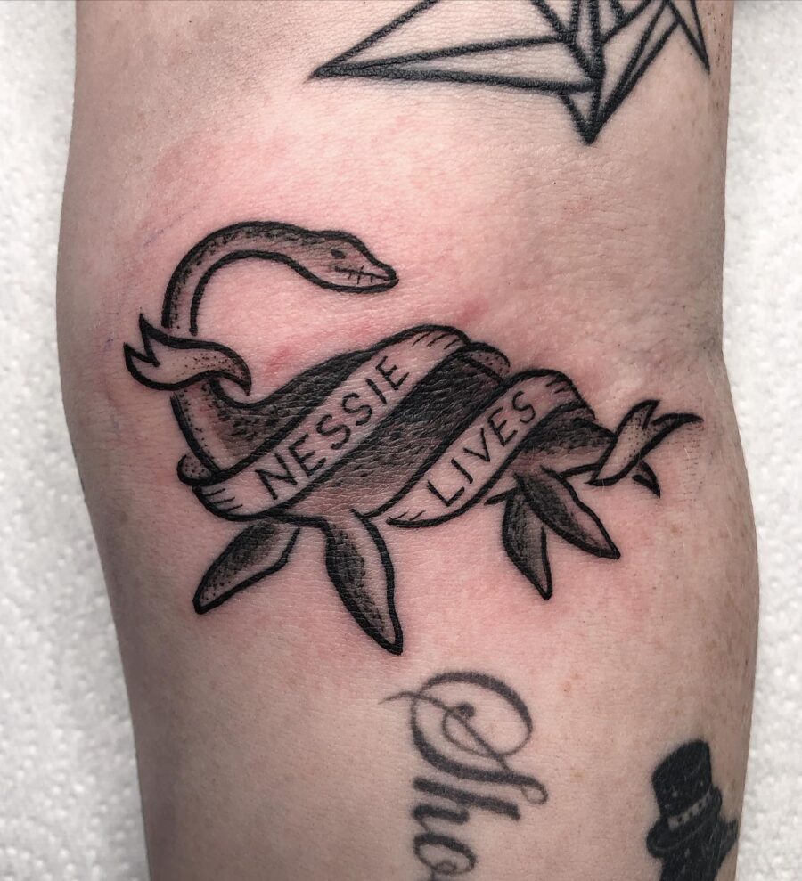 Whimsical Nessie tattoo with inspirational text