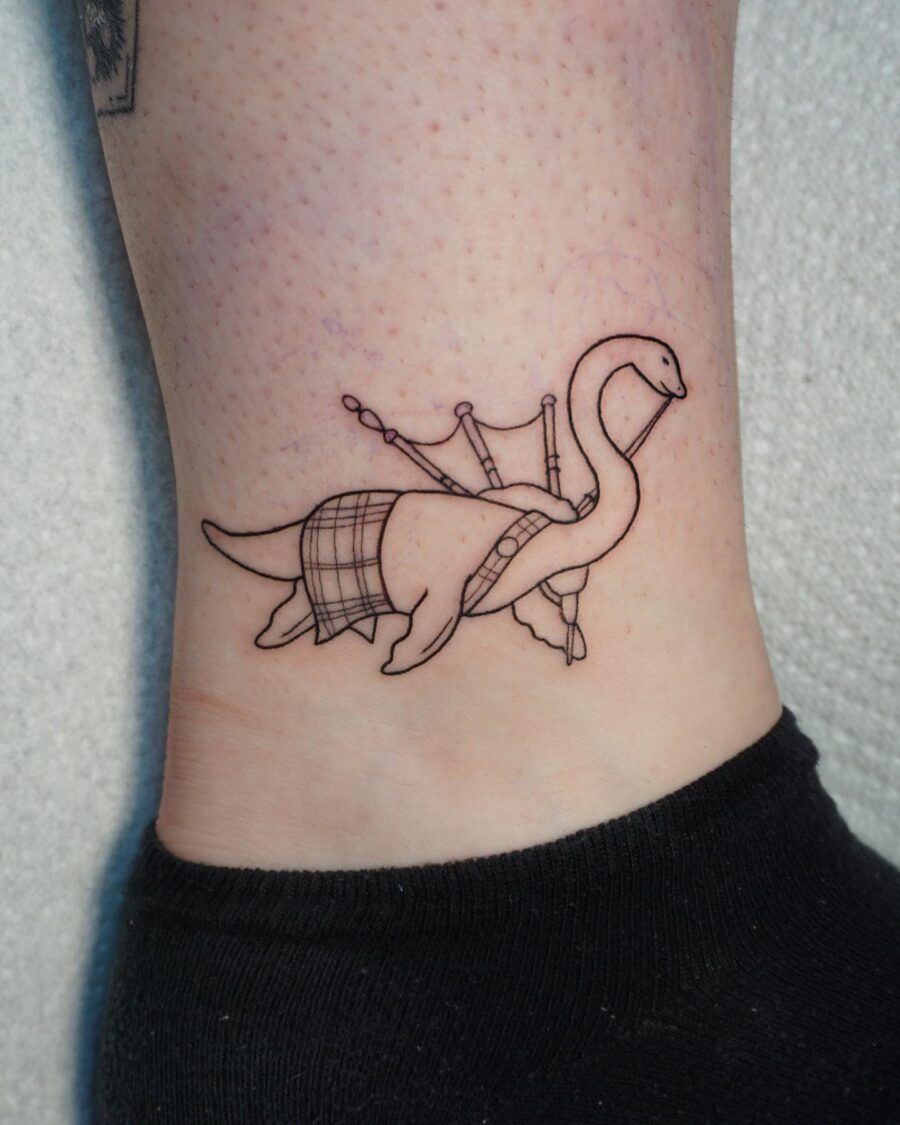 Charming Loch Ness Monster Tattoo with Bagpipes