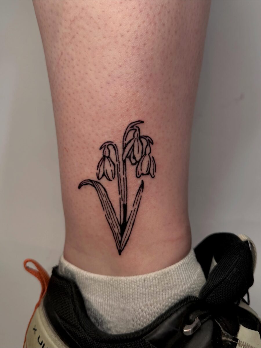 Elegant snowdrop flower tattoo on the ankle