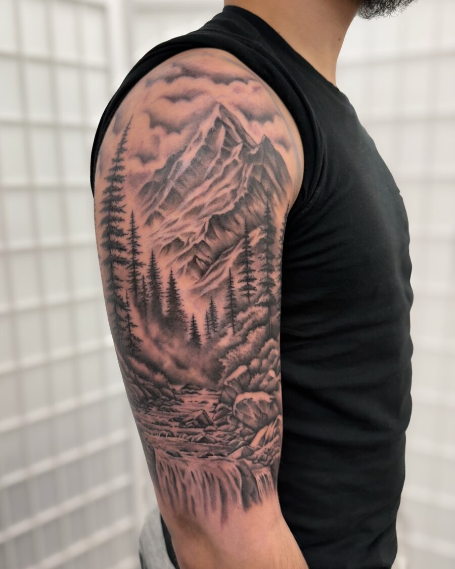 Stunning black and grey mountain landscape tattoo
