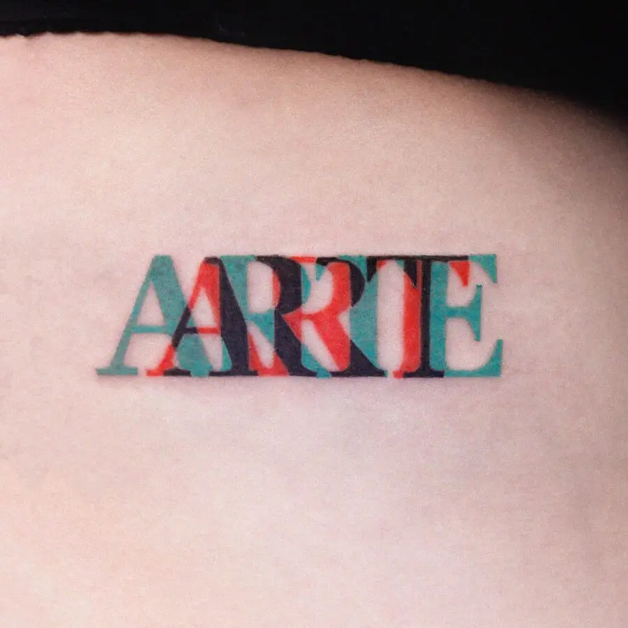 Vibrant one-word tattoo showcasing creativity