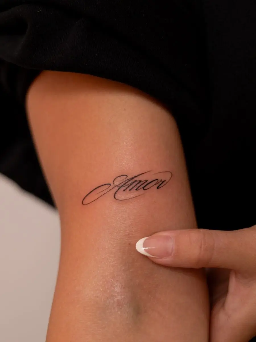 Elegant one-word tattoo showcasing love's essence