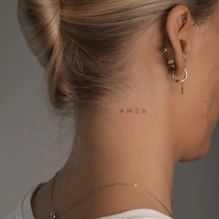Elegant neck tattoo showcasing the word 'Amor'
