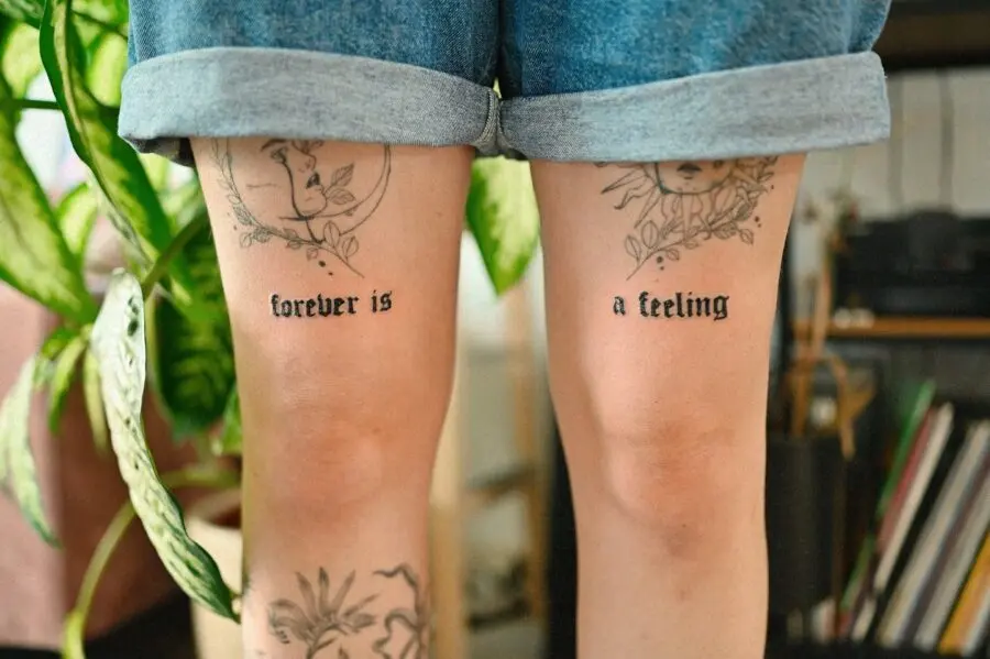 Expressive one-word tattoos on the thighs