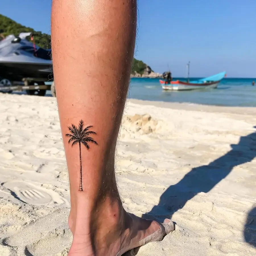 Stylish palm tree tattoo on the leg