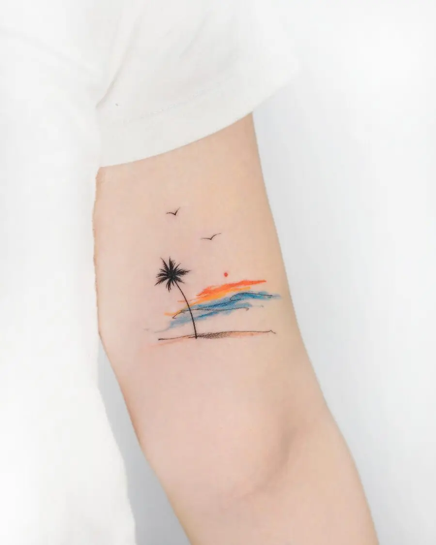 Minimalist palm tree tattoo with sunset vibes