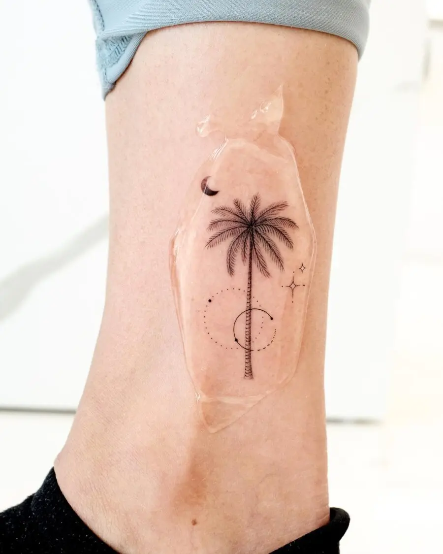Elegant palm tree tattoo on the ankle.