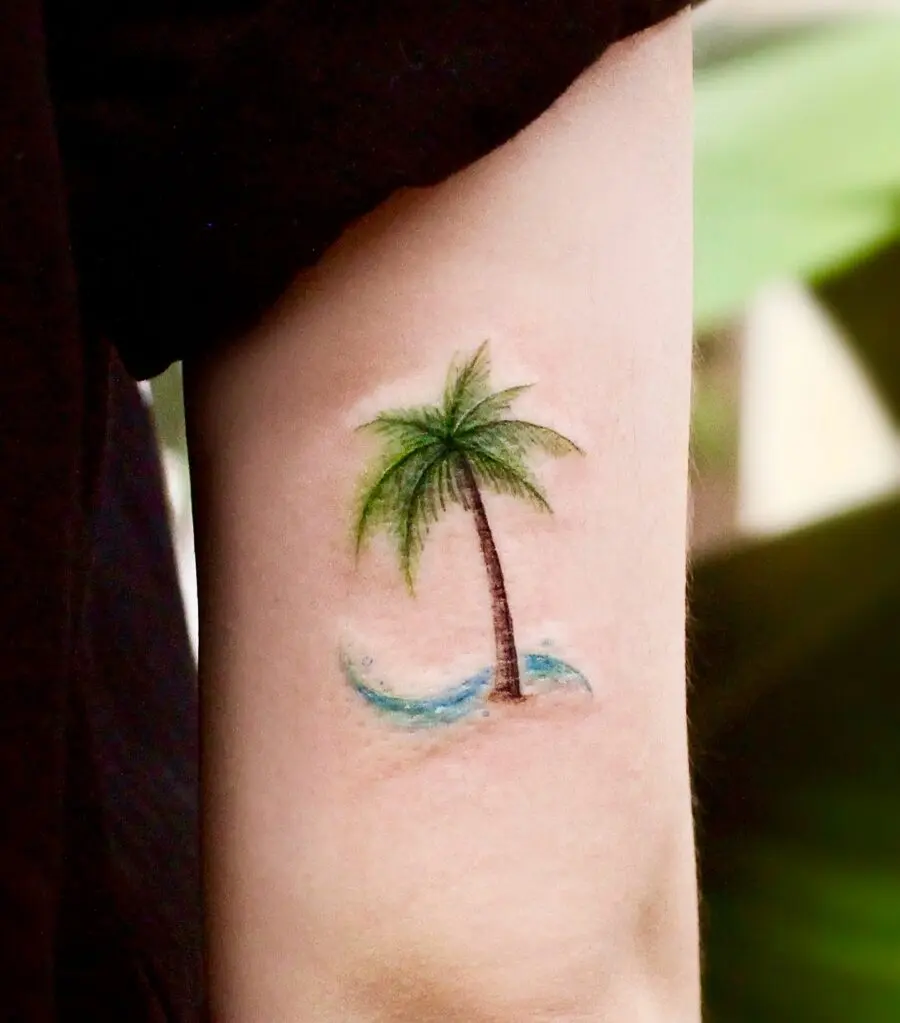 Charming palm tree tattoo with water elements
