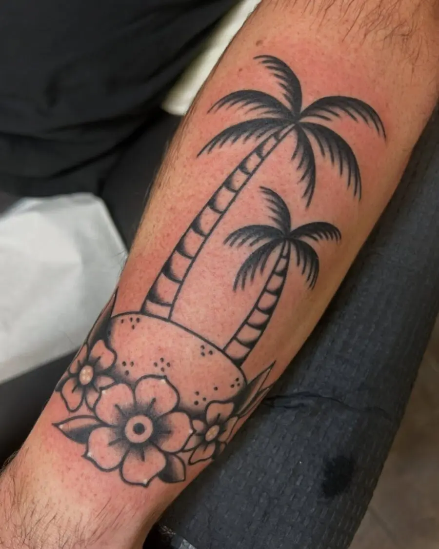 Elegant palm tree tattoo with floral accents
