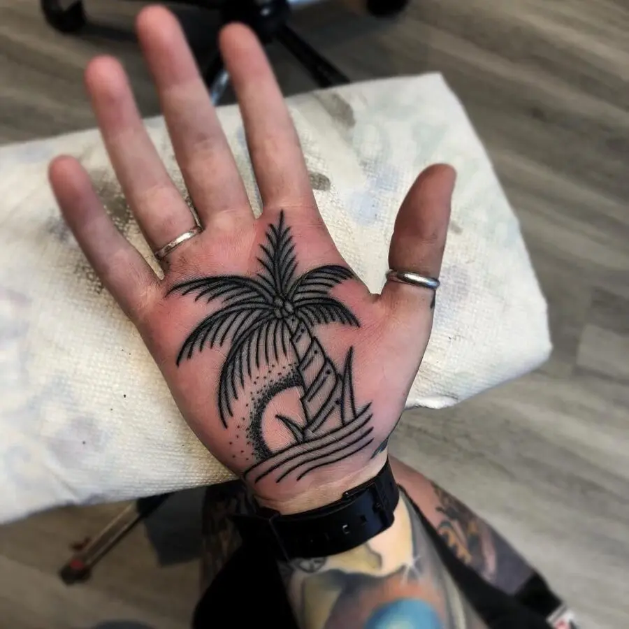 Stylish palm tree tattoo on a hand