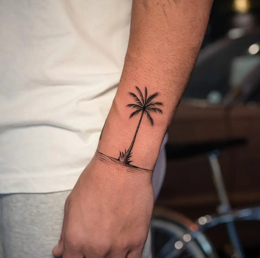 Minimalistic palm tree tattoo on forearm