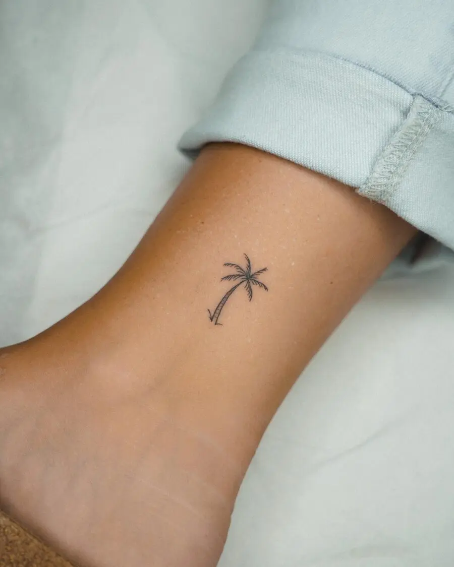 Minimalist palm tree tattoo on ankle