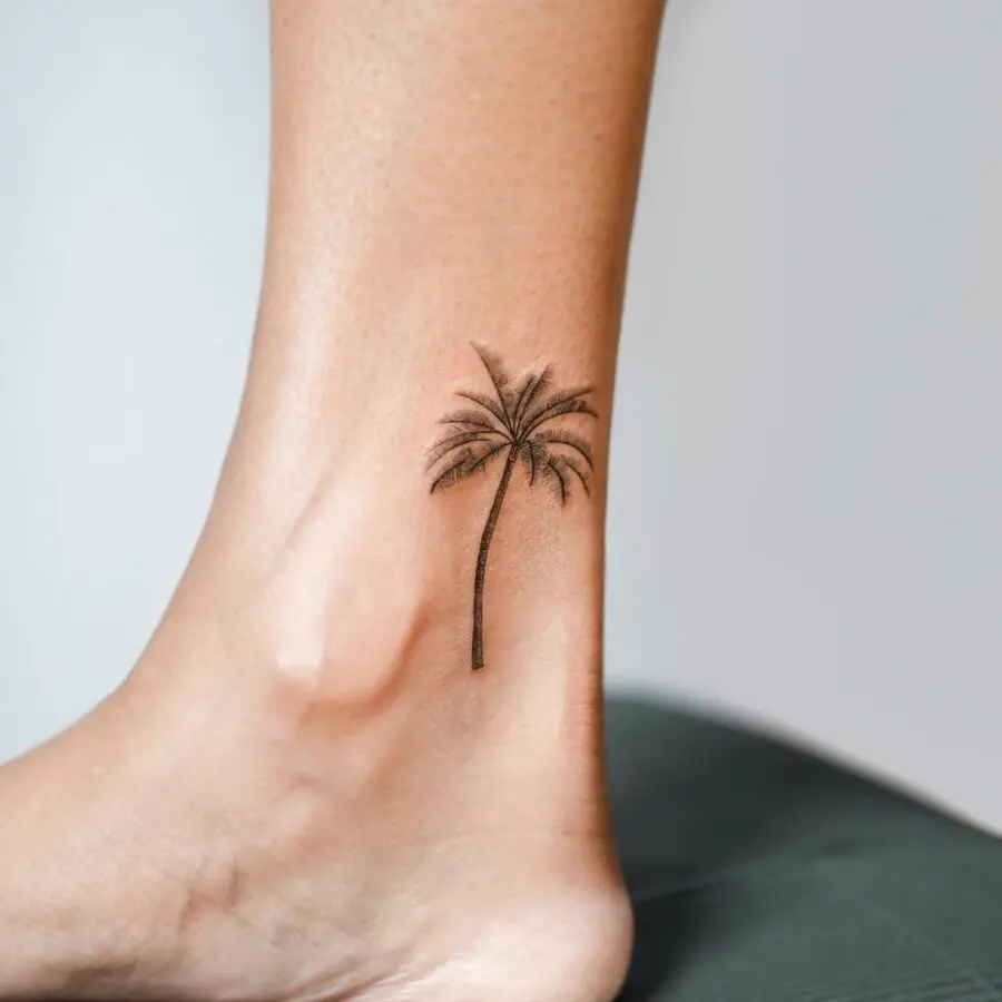 Minimalist palm tree tattoo on ankle area