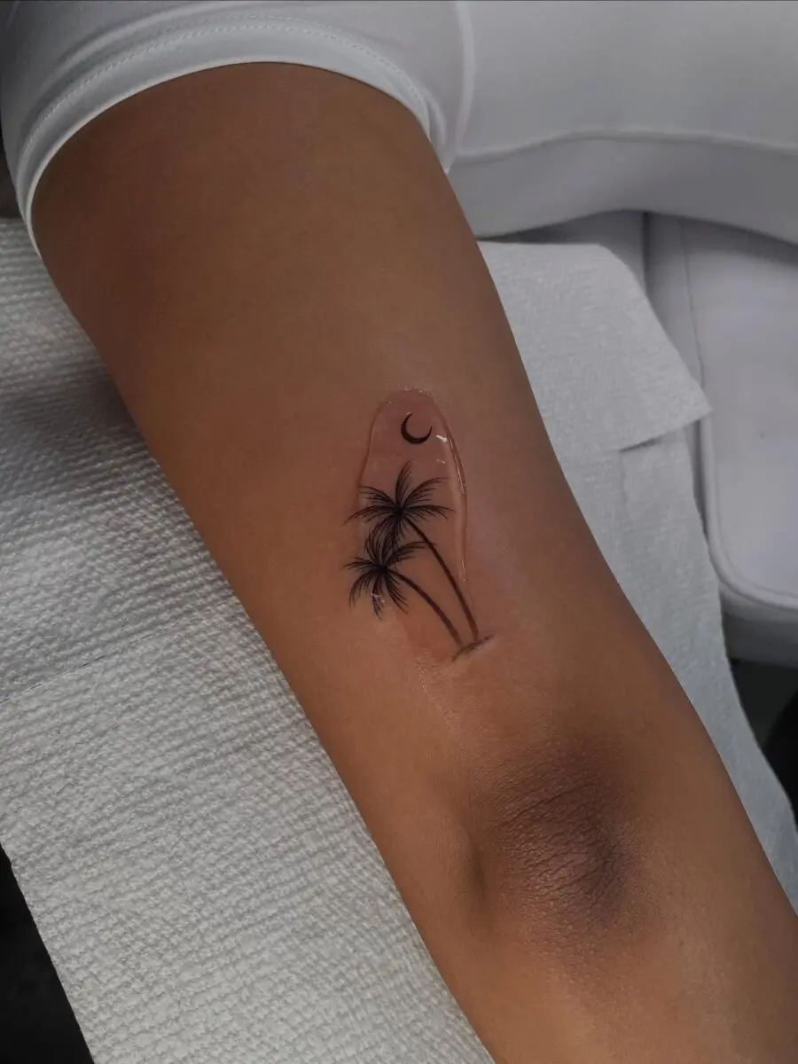 Elegant palm tree tattoo with moon accent
