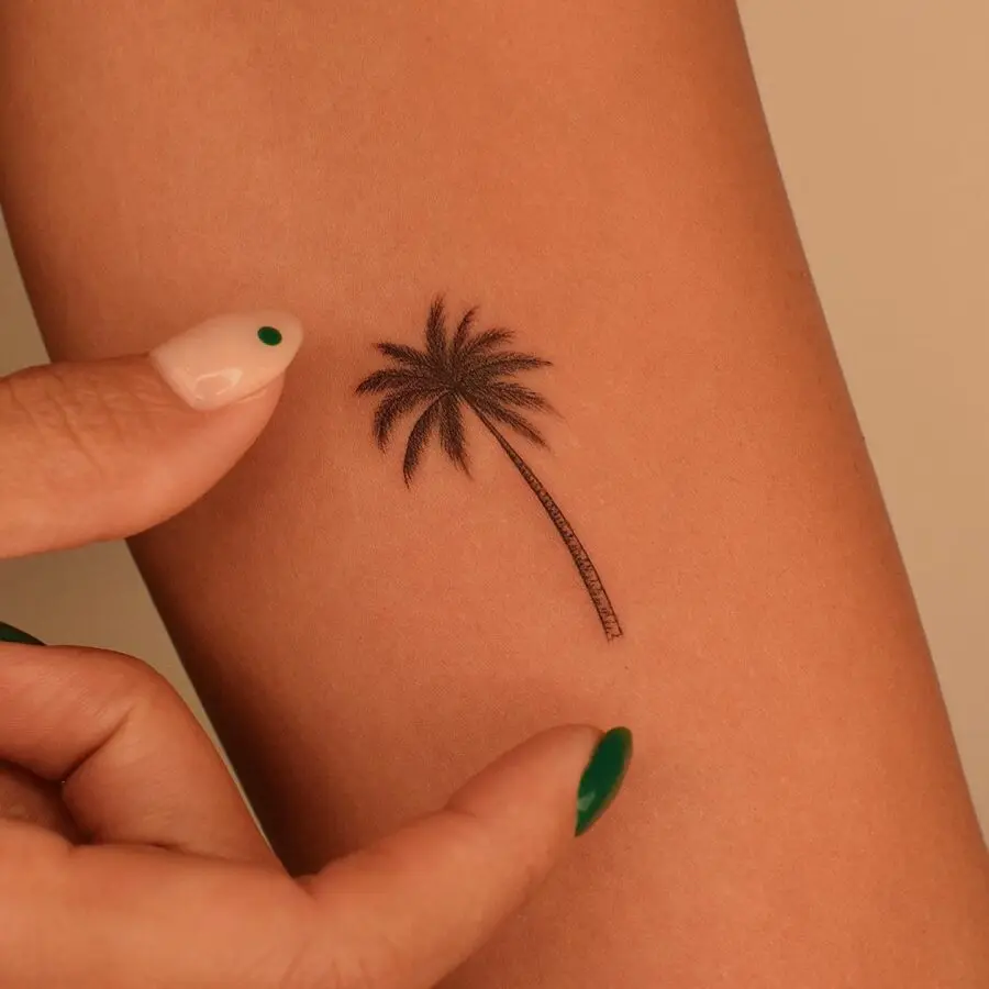 Elegant minimalistic palm tree tattoo design
