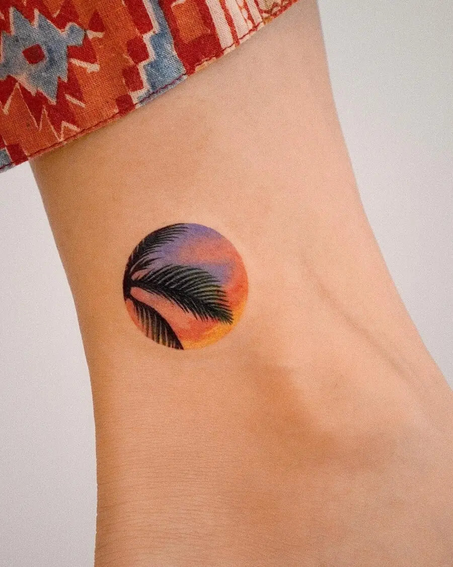 Vibrant sunset palm tree tattoo design