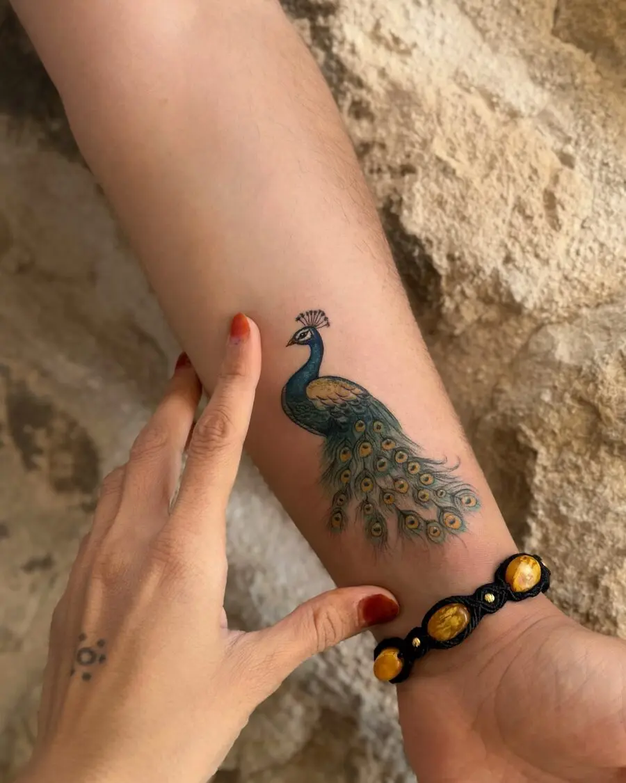 Elegant peacock tattoo showcasing colorful detail