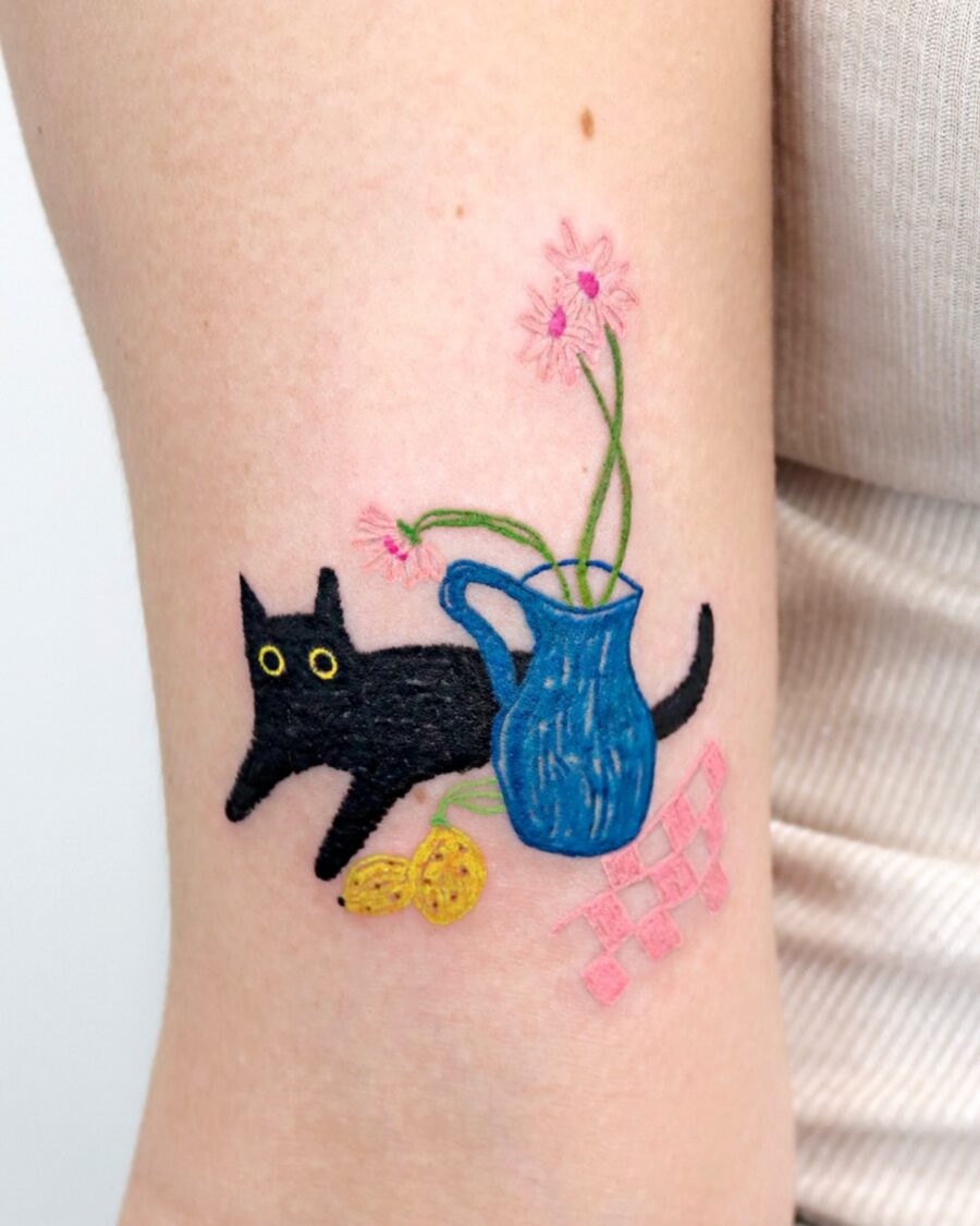 Playful black cat with vibrant petunia tattoo