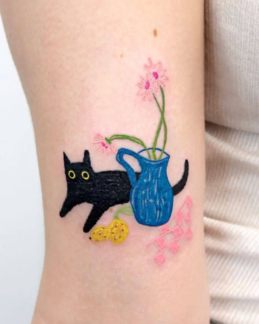 Playful black cat with vibrant petunia tattoo