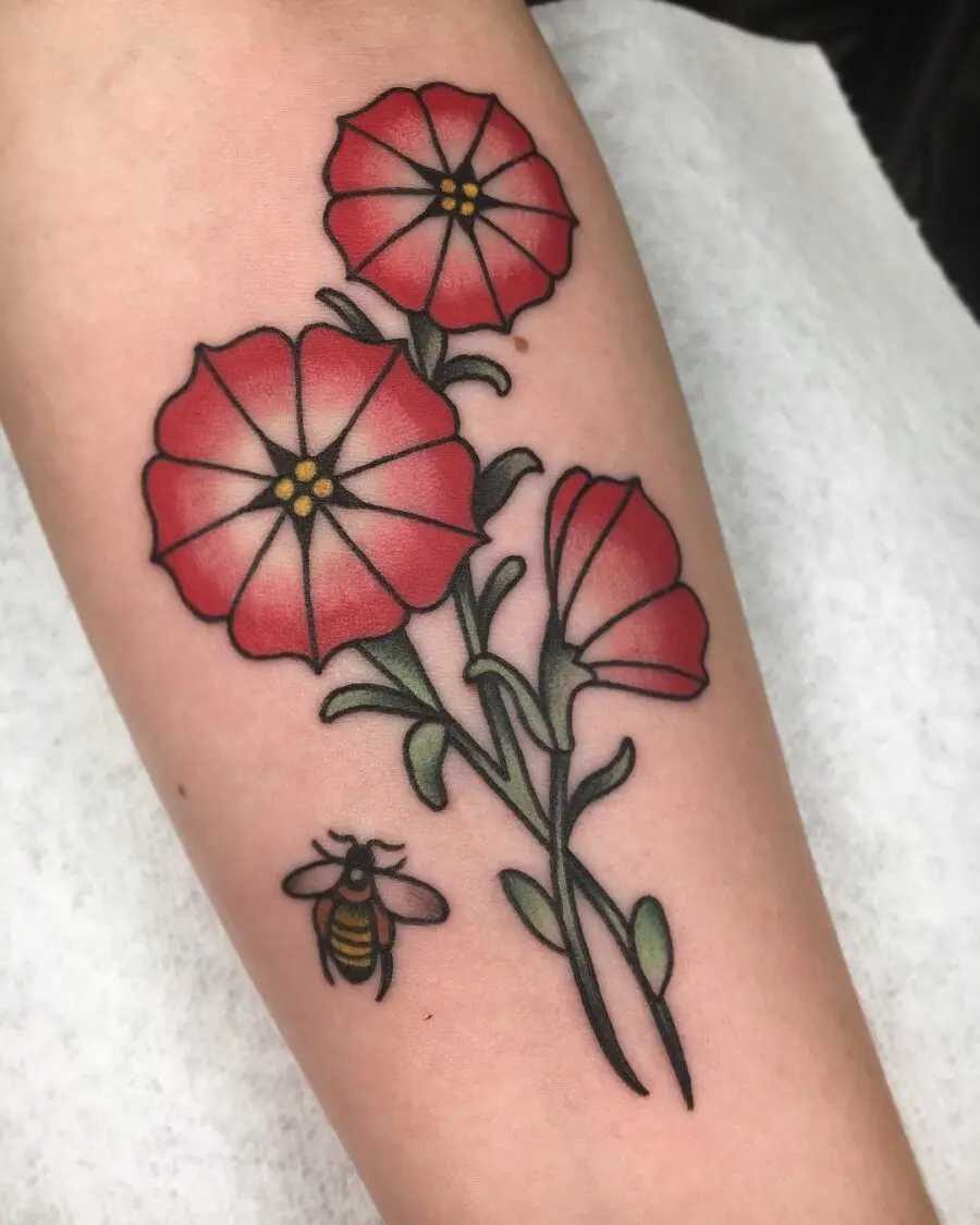 Vibrant red petunia tattoo with a buzzing bee
