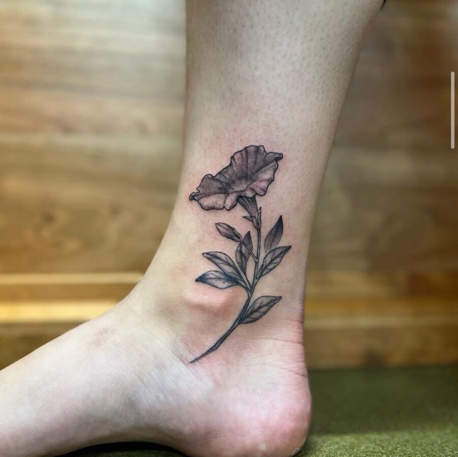 Elegant petunia tattoo gracing the ankle