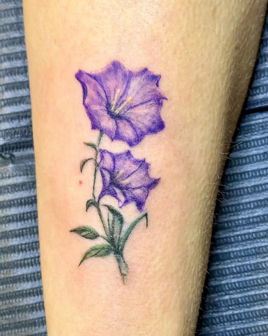 Stunning purple petunia tattoo on forearm
