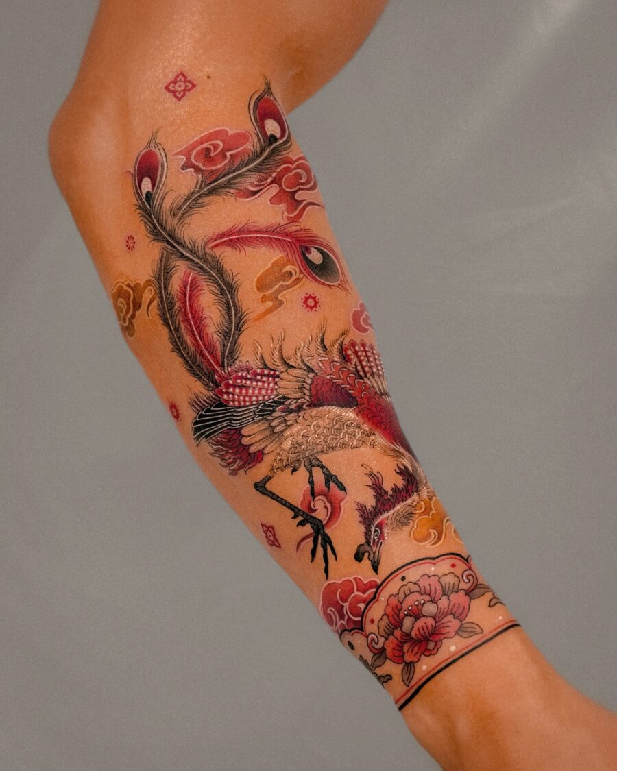Vibrant half sleeve tattoo featuring a phoenix