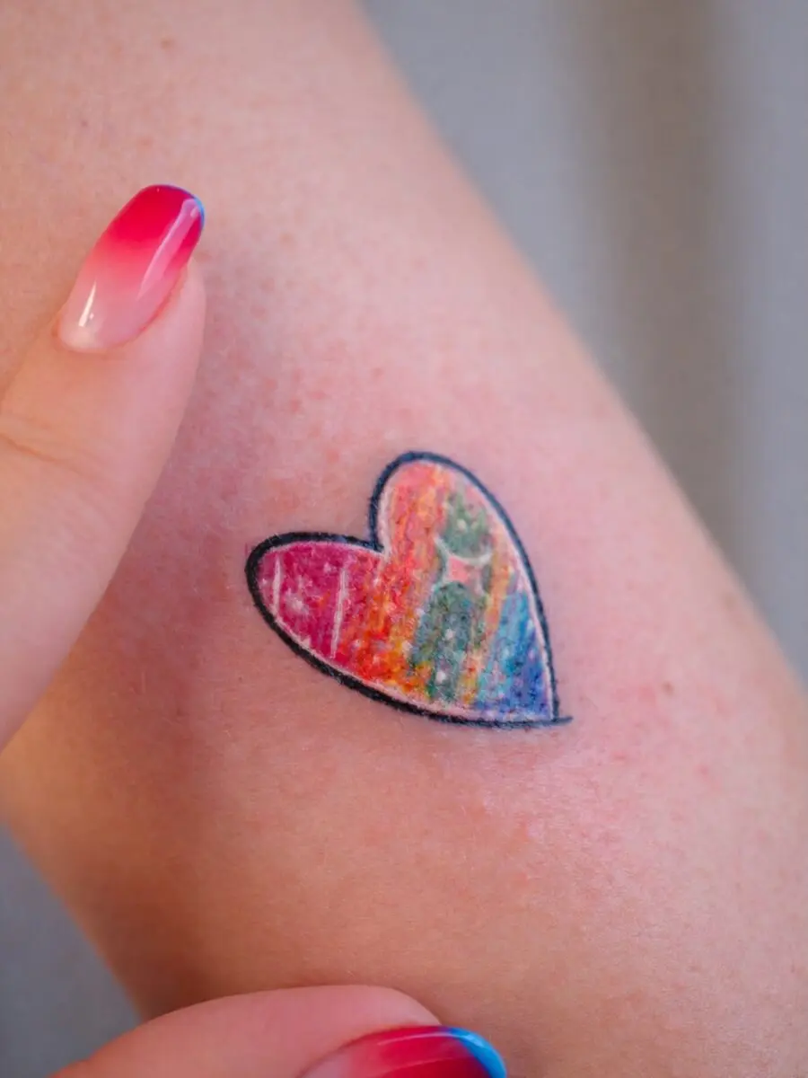 Vibrant heart tattoo celebrating rainbow babies