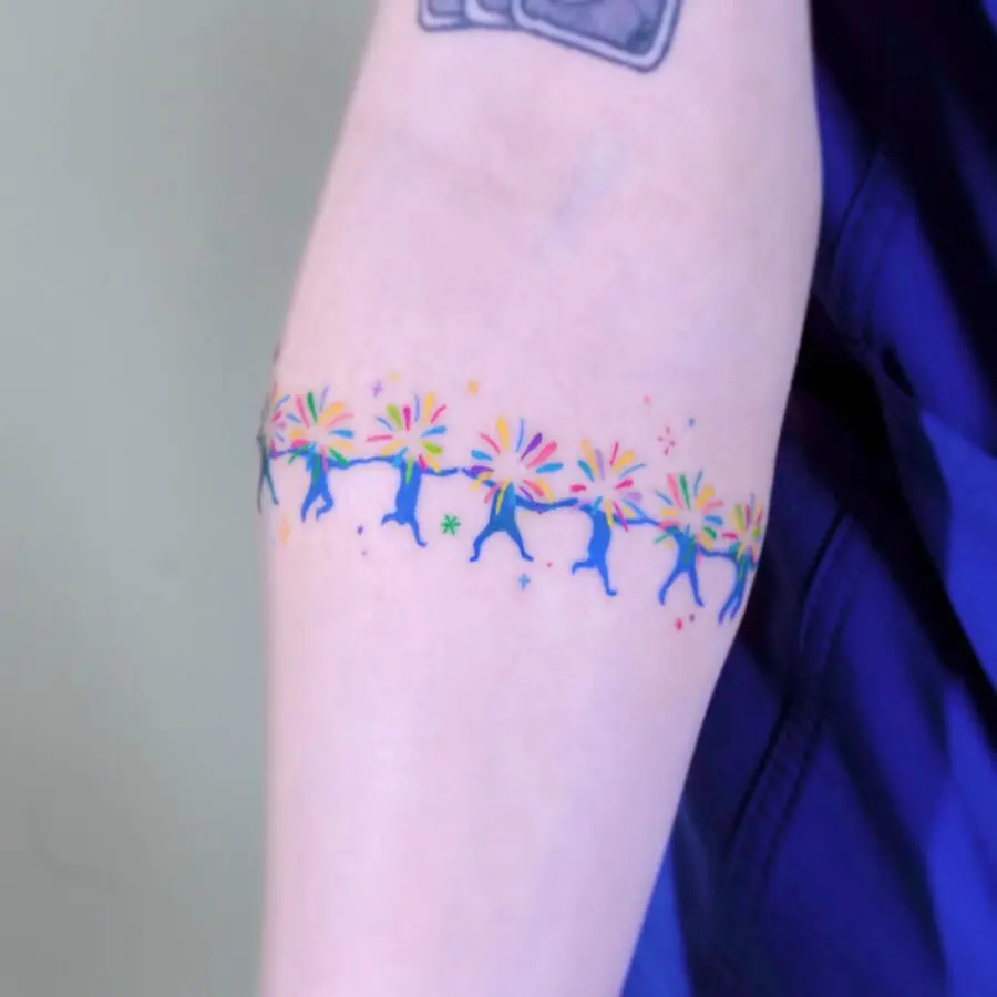 Vibrant rainbow baby tattoo on arm skin