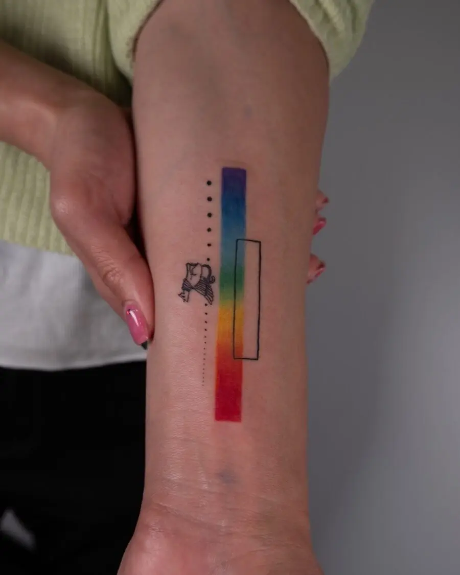 Colorful rainbow baby tattoo on the arm
