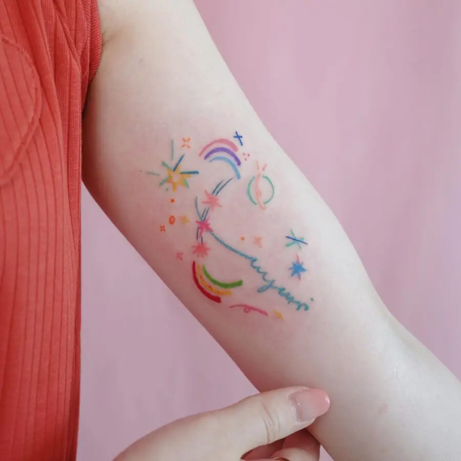 Vibrant rainbow baby tattoo with playful elements