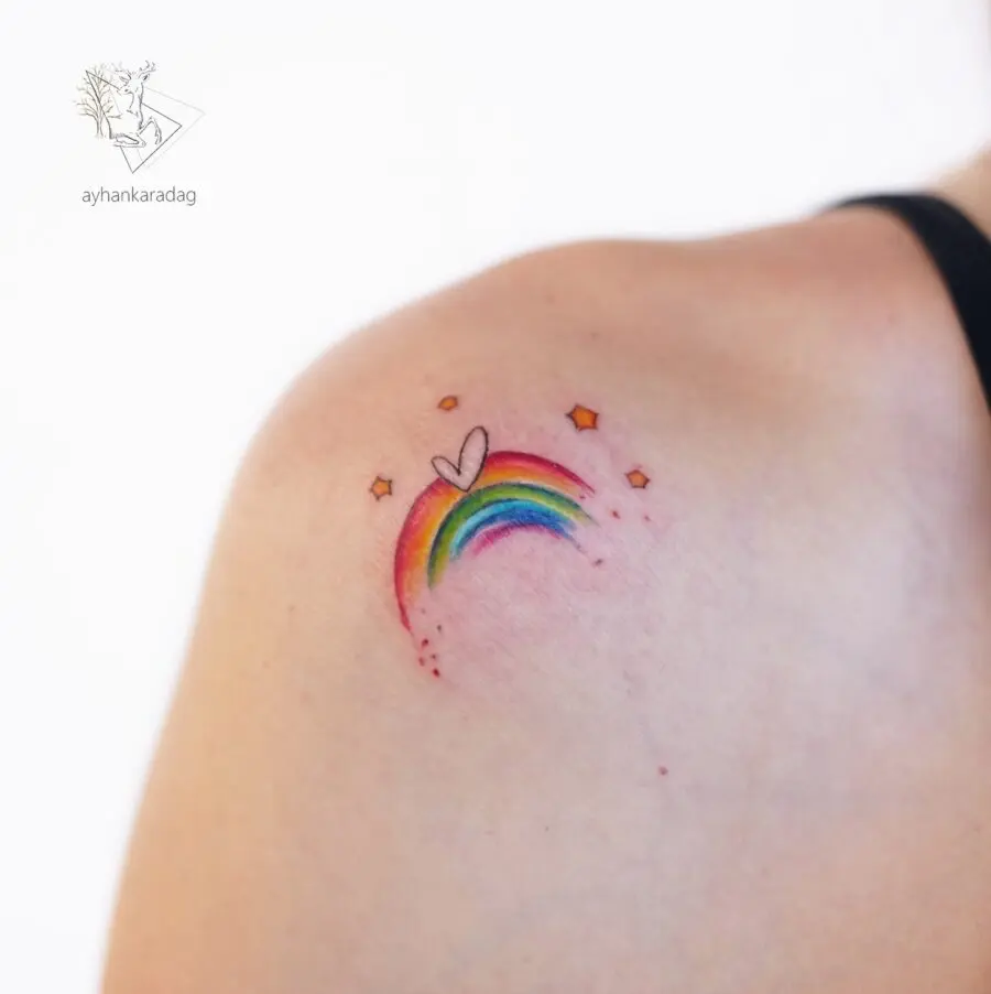 A delicate rainbow baby tattoo with heart symbolism