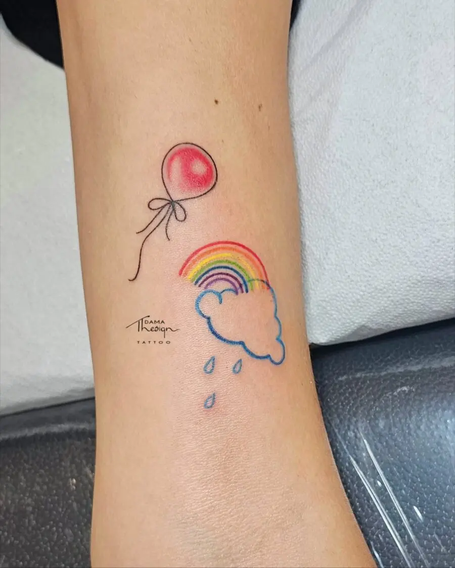 Whimsical rainbow baby tattoo with balloon