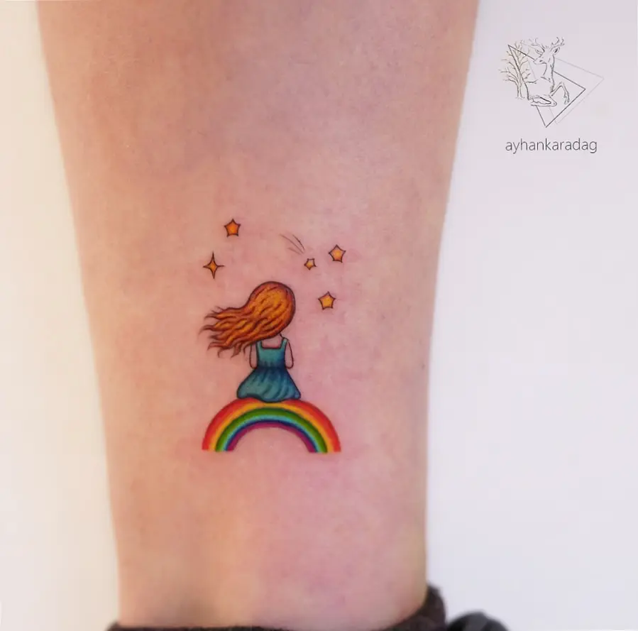 Whimsical rainbow baby tattoo with girl figure