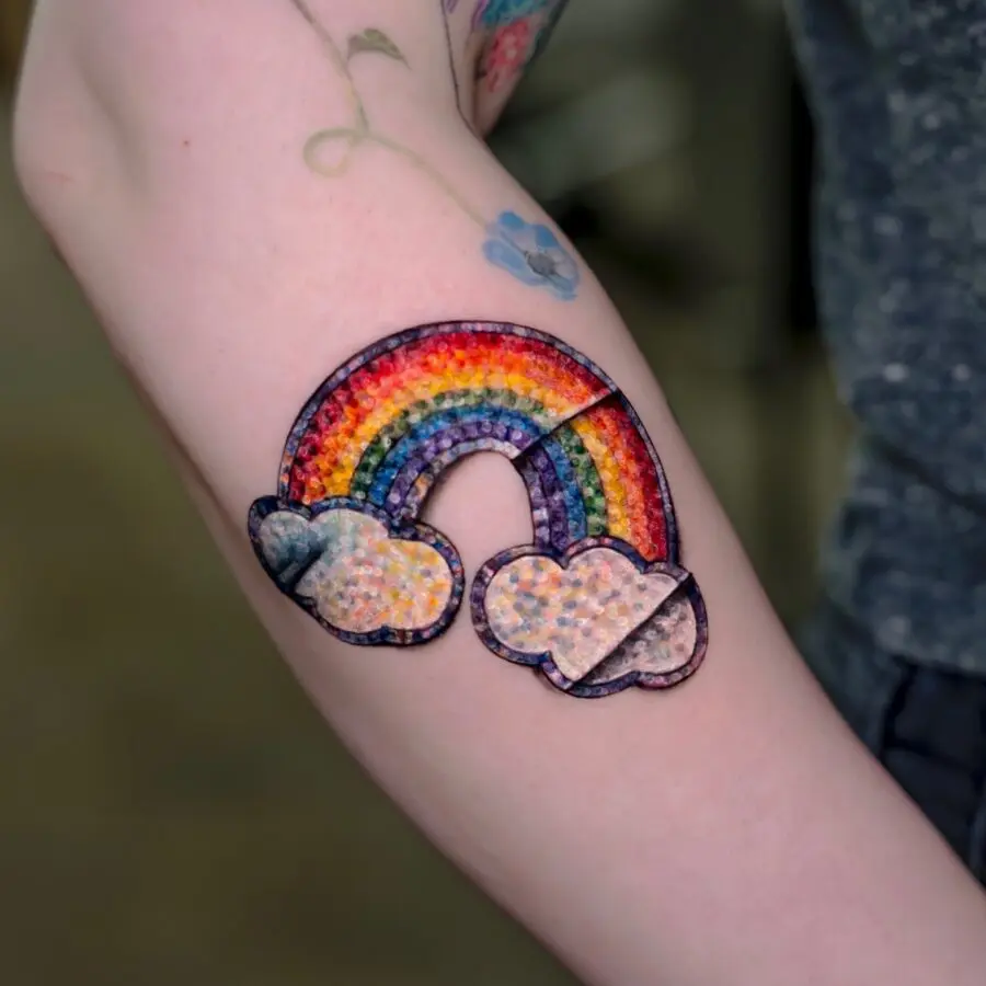 Vibrant rainbow baby tattoo with clouds