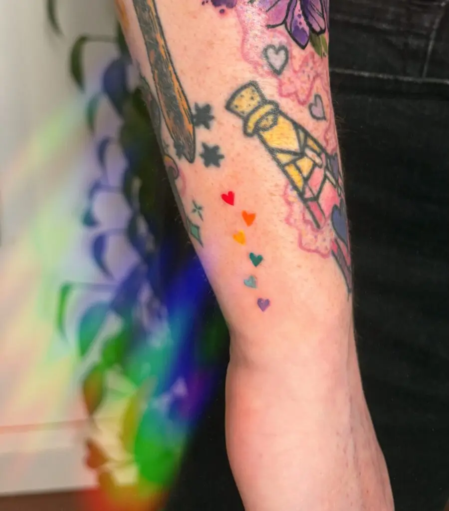 Colorful rainbow baby tattoo with hearts